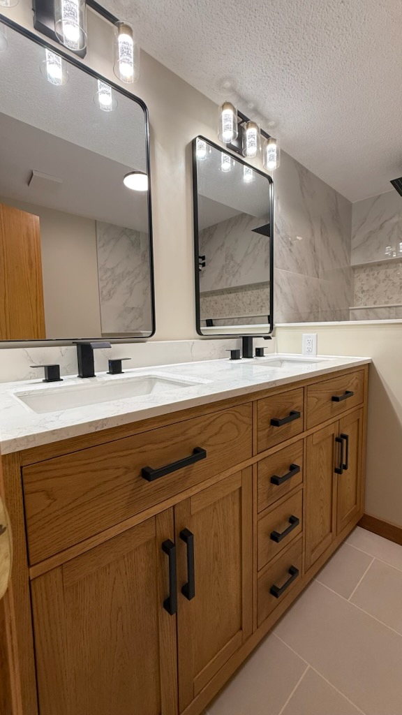 Oak double vanity with quartz top and matte black mirrors